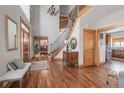 Stunning foyer with high ceilings, hardwood floors, elegant staircase, and a decorative chandelier at 900 Wilshire Dr, Berthoud, CO 80513