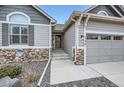Home with attractive stone veneer details and easy access to the three-car garage at 1798 Summerglow Ln, Monument, CO 80132