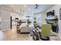 Open-concept living room featuring vaulted ceilings, fireplace, and hardwood floors at 1798 Summerglow Ln, Monument, CO 80132