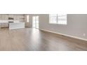 Open floor plan seamlessly blends the living room and kitchen with hardwood floors and natural light at 1854 Westport Ave, Berthoud, CO 80513