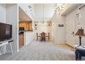 Open-concept living and dining area with high ceilings and plenty of natural light at 12728 Jasmine St # E, Thornton, CO 80602