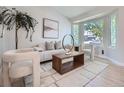 Bright living room features neutral furniture, stylish decor, hardwood floors, and natural light through large bay window at 17014 Carr Ave, Parker, CO 80134