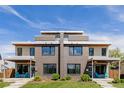 Contemporary home showcasing symmetrical design, brick accents, inviting porches, and lush landscaping creating curb appeal at 2004 S Galapago St, Denver, CO 80223