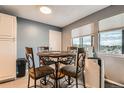 Charming dining area with a round table, four chairs, and a view of the outdoors at 8100 W Quincy Ave # 11, Denver, CO 80123