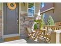 Small front porch with a table and chairs for relaxing at 3338 Youngheart Way, Castle Rock, CO 80109