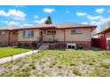 Charming single-story home with brick accents, covered porch and walkway with beautiful landscaping at 3559 Hudson St, Denver, CO 80207
