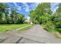 Long paved driveway leading to a single story house with large lawn at 1930 Hoyt St, Lakewood, CO 80215
