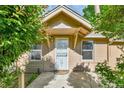 Close up of front porch showing door and house number surrounded by greenery at 1930 Hoyt St, Lakewood, CO 80215