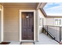 Condo front door with visible unit number, featuring a ramp and railing accessibility at 6001 S Yosemite St # H204, Greenwood Village, CO 80111
