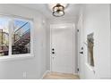 Bright entryway featuring a closet, light fixture, and view of the exterior staircase from inside at 6001 S Yosemite St # H204, Greenwood Village, CO 80111
