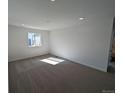 Spacious carpeted bedroom with large windows and a neutral color palette ready for customization at 8205 Rockvale Dr, Littleton, CO 80125