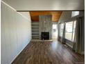 Open living area with beamed ceilings, tile fireplace, and built-in shelving for style and function at 2441 S Xanadu Way # A, Aurora, CO 80014