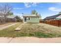 Charming single-story home featuring light green siding, a welcoming front door, and a compact yard at 741 Quitman St, Denver, CO 80204