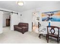 Bright living room featuring fresh paint, with a view into the kitchen and another room at 741 Quitman St, Denver, CO 80204