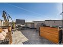 Inviting rooftop deck with a grill, comfortable seating, and open sky at 3880 W 13Th Ave, Denver, CO 80204