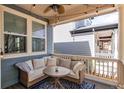 Relaxing covered porch with cushioned seating, fan and string lights at 3353 Wabash St, Denver, CO 80238