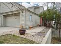 A lovely home featuring a large garage, neutral exterior, and rock landscaping at 758 Chimney Creek Dr # C, Golden, CO 80401