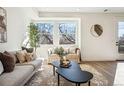 Cozy living room with abundant natural light, modern decor, and comfortable seating arrangement at 1416 Pierce St, Lakewood, CO 80214