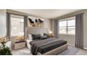 Serene main bedroom with ample natural light, stylish decor, and a comfortable king-sized bed at 27694 E Byers Ave, Aurora, CO 80018