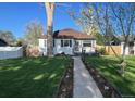 Updated home with a landscaped front yard and walkway at 1160 Wabash St, Denver, CO 80220