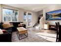 Cozy living room with a large window, comfortable sofa, and modern decor accents at 1312 Independence St # 3, Lakewood, CO 80215