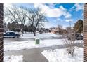Street view with snow covered sidewalks and a building across the street on a bright, partly cloudy day at 1312 Independence St # 3, Lakewood, CO 80215