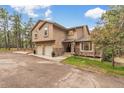Lovely two-story home with stone accents, a two-car garage, and an attractive entryway at 17540 Caribou Dr, Monument, CO 80132