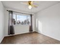 Simple bedroom with tile floors and window at 906 S Peoria St, Aurora, CO 80012