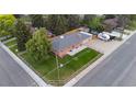 Aerial view of a fenced-in yard, brick home, and driveway with trailer parking at 5320 W 62Nd Ave, Arvada, CO 80003