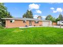 Charming single-story brick home with a well-manicured front yard and attached garage at 5320 W 62Nd Ave, Arvada, CO 80003