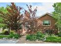 Beautiful brick home featuring a walkway, manicured lawn and mature trees at 4000 Irving St, Denver, CO 80211