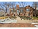 Classic brick home with manicured lawn and welcoming front entrance and brick walkway at 4000 Irving St, Denver, CO 80211