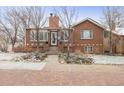 Inviting brick home with charming front garden and walkway, showcasing classic appeal at 4000 Irving St, Denver, CO 80211