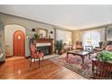 Warm living room with hardwood floors, fireplace, and abundant natural light through sheer curtains at 4000 Irving St, Denver, CO 80211