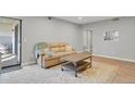 Inviting living room with a sliding glass door and a comfortable sofa at 3872 S Fraser St # O03, Aurora, CO 80014