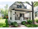 Charming home featuring a covered porch, decorative gables, and landscaped front yard at 858 S Emerson St, Denver, CO 80209