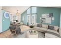 A bright living room with high ceilings, a dining area, and modern decor at 12690 W Brandt Dr, Littleton, CO 80127