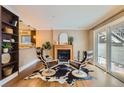 Inviting living room featuring a cozy fireplace, stylish seating, and sliding glass doors to the private balcony at 275 Pearl St # 11, Boulder, CO 80302