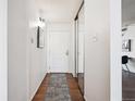 Inviting hallway with wood floors, mirrored closet, and white door at 1020 15Th St # 28G, Denver, CO 80202