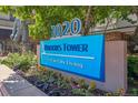 Brooks Tower, First in City Living sign surrounded by decorative landscaping at 1020 15Th St # 28G, Denver, CO 80202