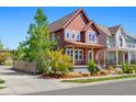 Charming two-story home featuring a cozy front porch and vibrant landscaping at 1691 W 66Th Ave, Denver, CO 80221