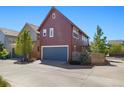 Exterior view of a home with a spacious two-car garage and modern design at 1691 W 66Th Ave, Denver, CO 80221