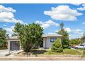 Inviting single-story home with manicured front yard and an attached garage perfect for new homeowners at 2767 W Iliff Ave # 1, Denver, CO 80219