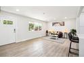 Bright living room featuring wood-look flooring and a modern design with neutral colors at 2767 W Iliff Ave # 1, Denver, CO 80219