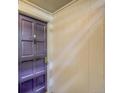 Close-up of a purple front door with secure access panel and white trim at 7318 S Xenia Cir # B, Centennial, CO 80112