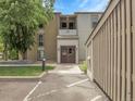 Inviting condo entrance with a well-lit walkway and manicured lawn at 7318 S Xenia Cir # B, Centennial, CO 80112