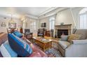 Comfortable living room featuring a fireplace, hardwood floors, and large windows with shutters at 1100 Cherokee St # 304, Denver, CO 80204
