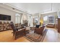Spacious living room boasts a fireplace, large windows with shutters, and hardwood floors at 1100 Cherokee St # 304, Denver, CO 80204