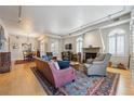 Bright living room featuring a fireplace, shutters, hardwood floors, and stylish furniture at 1100 Cherokee St # 304, Denver, CO 80204