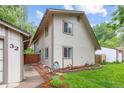 View of the home's exterior, including a detached garage, a well-maintained lawn, and neat landscaping at 32 Powder Horn Pl, Longmont, CO 80504